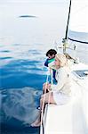 Young couple relaxing on sailboat, Adriatic Sea