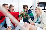 Group of friends drinking beer on sailboat, Adriatic Sea