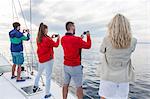 Group of friends taking pictures on sailboat, Adriatic Sea