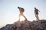 Young couple hiking in mountain landscape