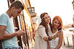 Young people in hippie style fashion taking self portrait