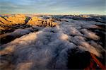 Aerial shot of Sella Group Alps surrounded by clouds at sunset in the Dolomites, Val Funes, Trentino-Alto Adige South Tyrol, Italy, Europe