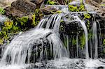 Small stream cascading over rocks in mountains of Kilauea, Kauai, Hawaii, United States of America, Pacific