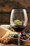 Red wine with Cheese variety.Food background.  Fresh snacks on wood