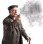Old man reflecting while smoking his pipe