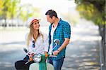 Young couple on a scooter outdoors