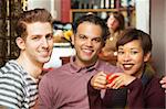 Handsome trio of adults having coffee at bistro