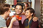 Diverse group of adults toasting with coffee cups