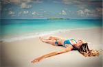 Girl tan lying seashore on the sand