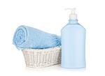 Shampoo bottle and blue towel. Isolated on white background