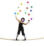 Clown as juggler is balancing on rope