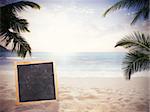 Blackboard on the sand at the beach