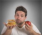 Man undecided between diet and junk food