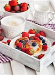 Cheese pancakes (syrniki) with fresh strawberry, raspberry,  blueberry and coffee on the tray