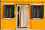 bright yellow typical house facade of Burano island, Venice, Italy