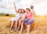 Group of friends having a good time outdoors in a field