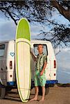 Single person with eyeglasses posing with surfboard