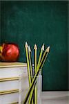 School objects for students. Chalkboard, pencils, crayons and apple