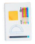 Ruled notebook with school supplies isolated on white background