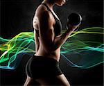 Muscular woman workout with light effect background