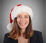 Businesswoman smiling with hat of Santa Claus