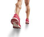 Legs of sporty woman running on white background