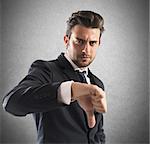 Negative mood businessman with a thumb down