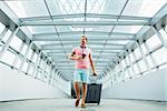 Young man with a suitcase at the airport