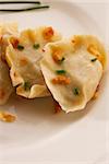 polish pierogi dish - dumplings with meat on white plate close up