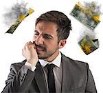 Angry businessman with money which are flammable