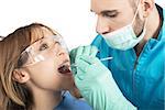 Dentist effects a cleaning of the teeth