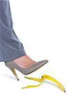 Woman with heel shoes walking on banana on white background