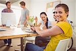 Portrait of a smiling young businesswoman in a meeting at office