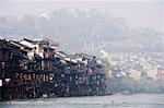 Wooden stilt houses in riverside old town of Fenghuang, Hunan Province, China, Asia