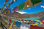 Prayer flags above an artifical lake near the Karo-La Pass, Tibet, China, Asia