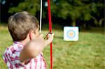 Rear view of teenage boy practicing archery