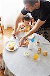 Father and son having breakfast