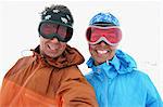 Smiling couple wearing skiing goggles