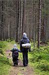 Mother with son walking in forest