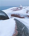 Building on rocky coast at winter