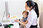 Businesswoman with baby girl in office