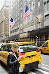 Woman using cell phone on street