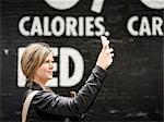 Woman taking photo with cell phone