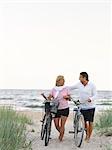 Couple with bicycles on beach