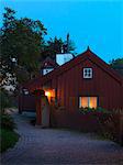 Illuminated wooden house at dusk