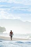 Central America, Costa Rica, Puntarenas, Nicoya peninsula, a male surfer on a beach near Santa Teresa