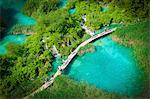 Plitvice Lakes, Croatia, Europe. tourists walking on the pier in the middle of the turquoise lakes