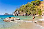 Dominica, St John Parish, Portsmouth, Secret Bay. A young lady runs along Secret Beach..