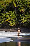 Dominica, Hampstead. A woman walks along No 1 Beach. .