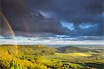 United Kingdom, England, North Yorkshire. A clearing storm and rainbow over Sutton Bank.